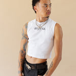 Man wearing a white sleeveless shirt with 'ardya' branding on a beige background